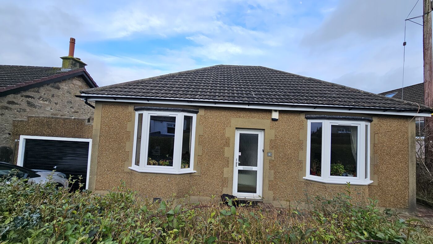 Front of property — original pebbledash render