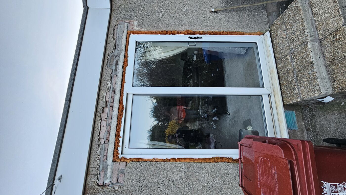Repair process — render damage exposed around patio door