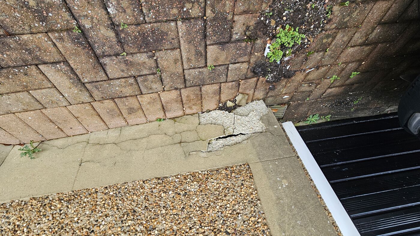Plinth repair — cracked render at garage corner