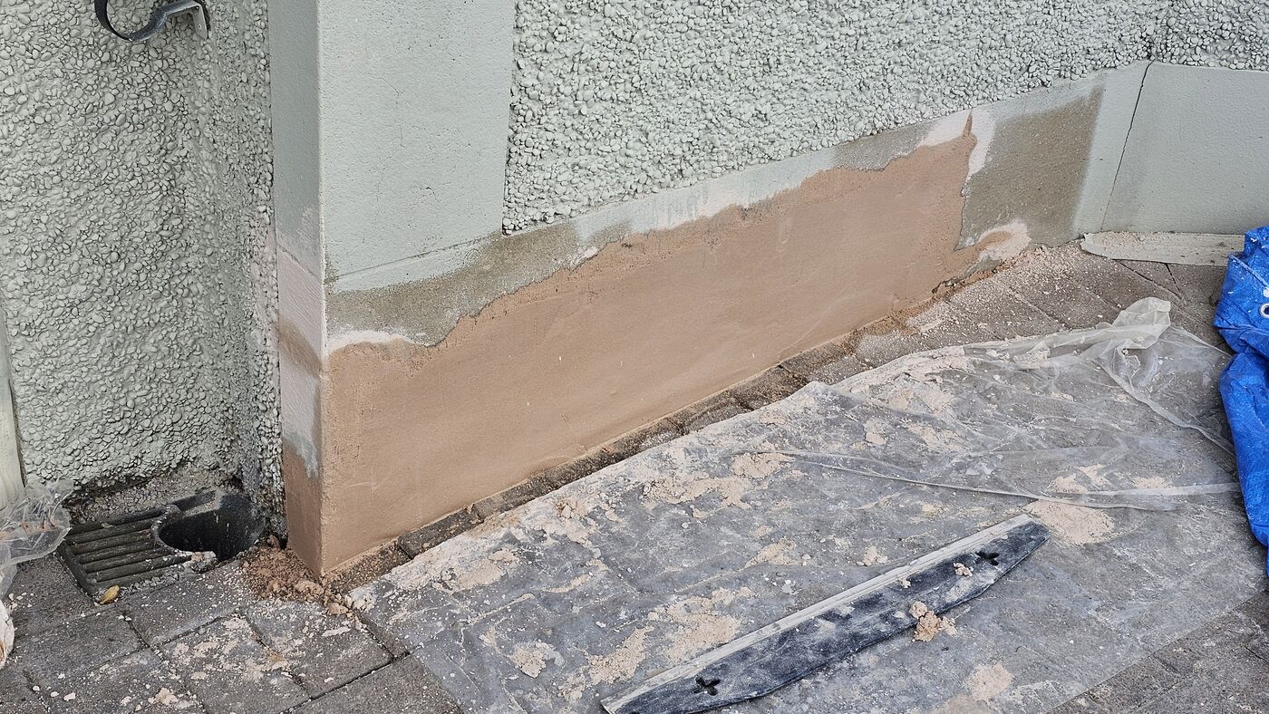 Render coat applied — plinth rebuilt full length